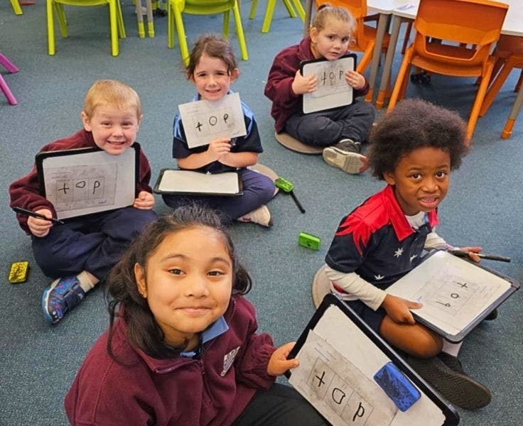 Students sitting on the floor learning