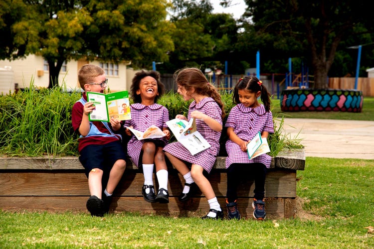 Students laughing and reading books