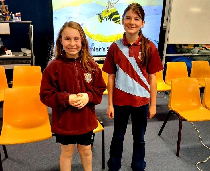 Two students smiling