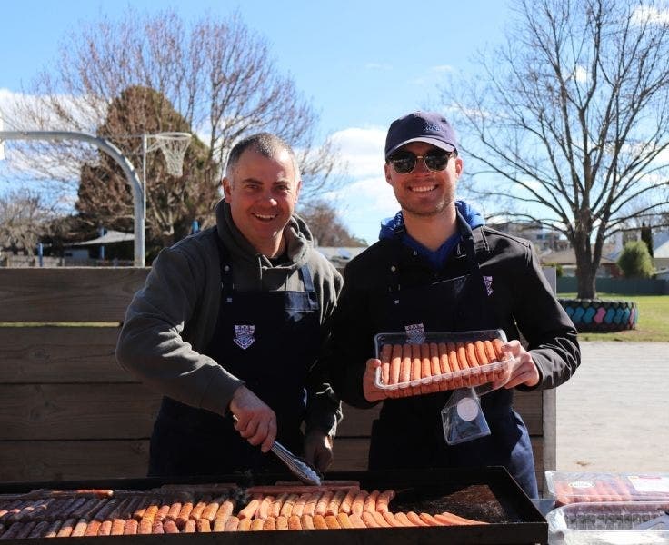 Two men cooking a barbeque