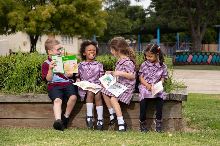 Students laughing and reading books
